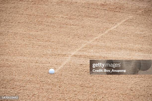 a golf ball falling on sand trap (or bunker) in golf course. - golf bunker stock-fotos und bilder