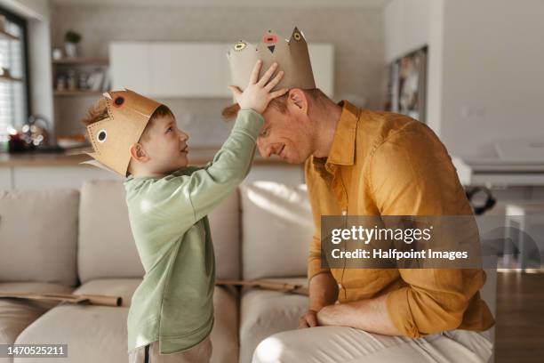 father and his son playing in their home. - coronation stock pictures, royalty-free photos & images