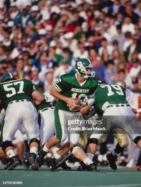 Jim Miller, Quarterback for the Michigan State Spartans in motion during the NCAA Big Ten Conference college football game against the University of...