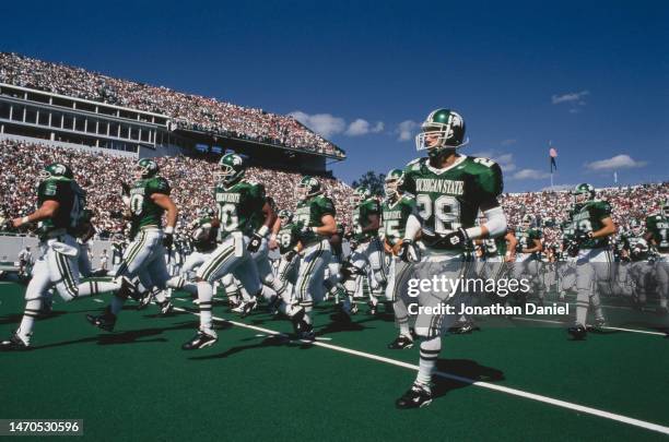 Players from the Michigan State Spartans run onto the field before the kick off for the NCAA Big Ten Conference college football game against the...