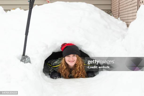 girl smiling from snow fort tunnel - open day 13 stock pictures, royalty-free photos & images