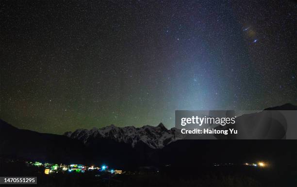 meteor and zodiacal light above himalayas - zodiacal light stock pictures, royalty-free photos & images