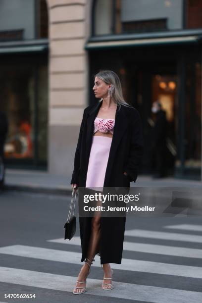 Saraja Roberta Elez seen wearing Magda Butrym light pink short dress with a cut-out and flower details, Magda Butrym silver diamond statement pendant...