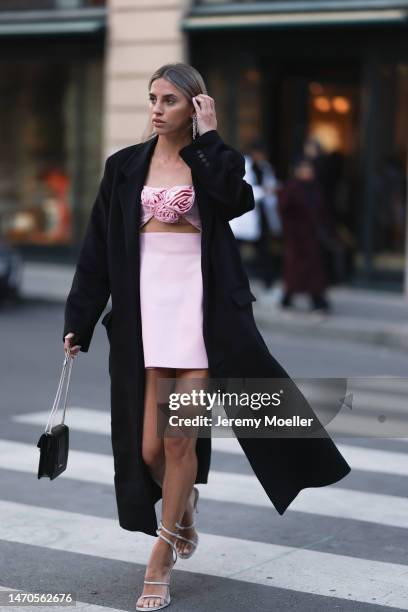 Saraja Roberta Elez seen wearing Magda Butrym light pink short dress with a cut-out and flower details, Magda Butrym silver diamond statement pendant...