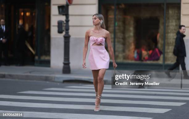 Saraja Roberta Elez seen wearing Magda Butrym light pink short dress with a cut-out and flower details, Magda Butrym silver diamond statement pendant...