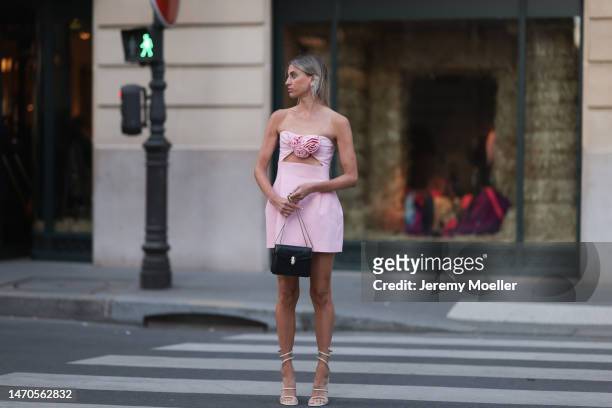 Saraja Roberta Elez seen wearing Magda Butrym light pink short dress with a cut-out and flower details, Magda Butrym silver diamond statement pendant...