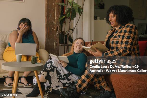 female colleagues laughing together - game night stock pictures, royalty-free photos & images