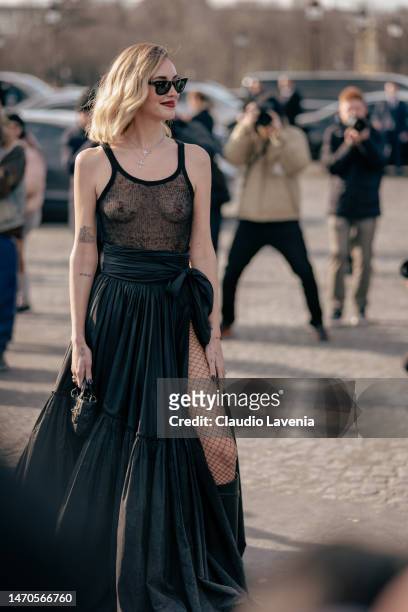 Chiara Ferragni wears a sheer black top, black maxi skirt, black boots, Dior bag and black Rayban sunglasses outside Dior, during Paris Fashion Week...