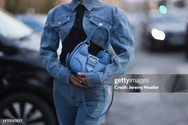 Saraja Roberta Elez seen wearing Mugler blue jeans denim cropped jacket, Mugler blue denim wide leg slit jeans pants, Prada Moon blue leather bag,...