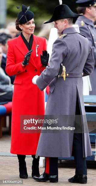 Officer of the Welsh Guards presents Catherine, Princess of Wales with the traditional St David's Day leek as she attends the St David's Day Parade...