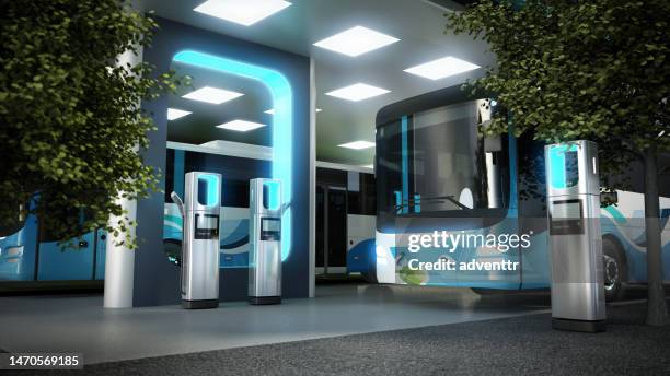 electric city bus recharging at the bus charge station, connected with a power cable - battery storage stock pictures, royalty-free photos & images