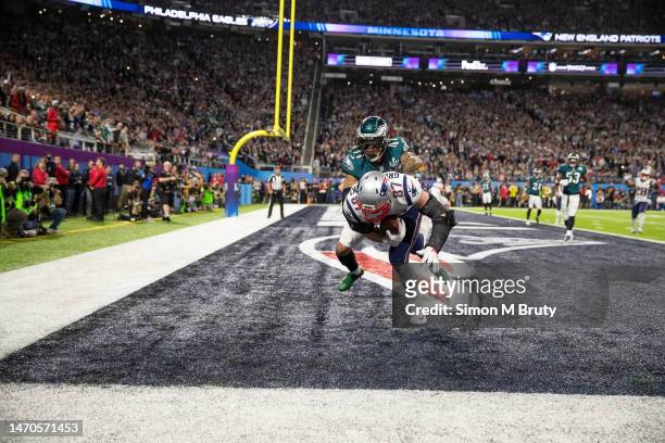 Rob Gronkowski of the New England Patriots makes a catch for a touch down even though he is tackled by De'Vante Bausby of the Philadelphia Eagles...