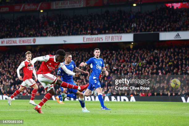 Bukayo Saka of Arsenal scores the team's first goal during the Premier League match between Arsenal FC and Everton FC at Emirates Stadium on March...