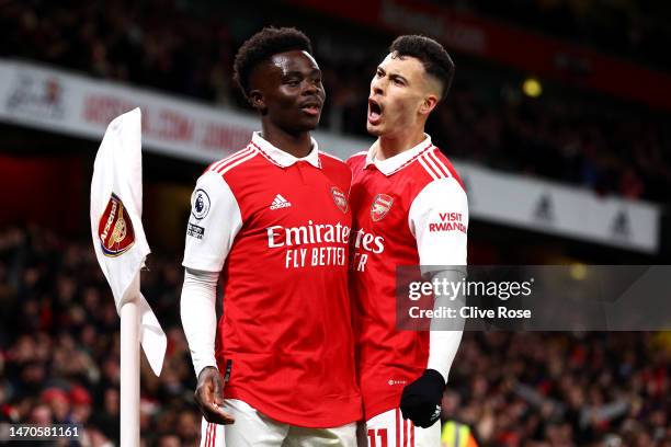 Bukayo Saka of Arsenal celebrates with teammate Gabriel Martinelli after scoring the team's first goal during the Premier League match between...