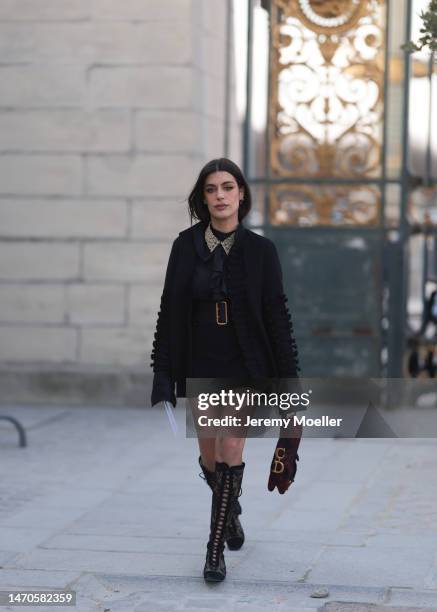 Aida Domenech seen wearing a black blazer, a black blouse, a black belt, black shorts, a red and black patterned Dior saddle bag and black...