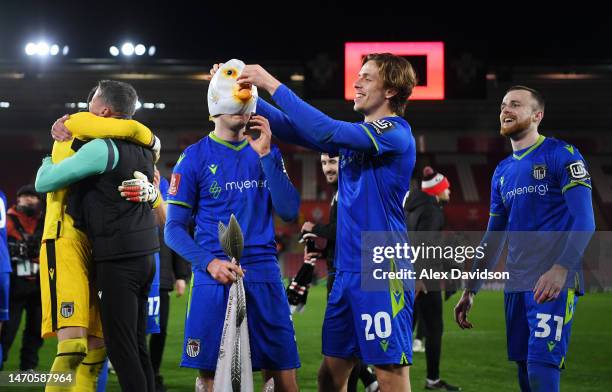 Anthony Driscoll-Glennon of Grimsby Town celebrates victory by wearing a fish mask with teammate Danilo Orsi-Dadomo at full time during the Emirates...