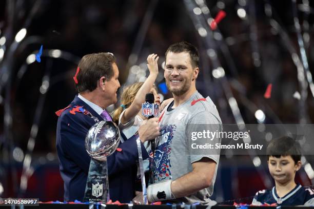 Tom Brady and his daughter Vivian Brady with Jim Nantz celebrating during the award ceremony for Super Bowl LIII at Mercedes-Benz Stadium on February...