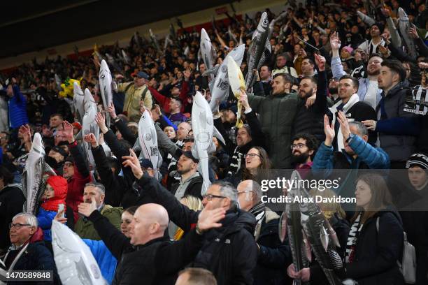 Grimsby Town fans celebrate by holding up Harry Haddock an inflatable fish following the Emirates FA Cup Fifth Round match between Southampton and...