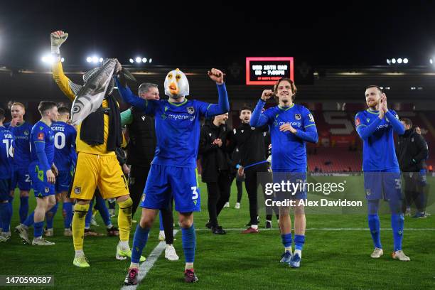 Anthony Driscoll-Glennon of Grimsby Town celebrates victory by wearing a fish mask with teammates at full time following the Emirates FA Cup Fifth...