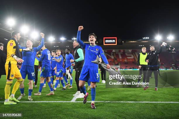 Anthony Driscoll-Glennon of Grimsby Town celebrates victory at full time holding Harry Haddock an inflatable fish during the Emirates FA Cup Fifth...