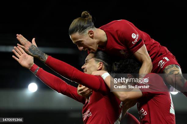 Darwin Nunez of Liverpool celebrates with teammate Stefan Bajcetic and Kostas Tsimikas after scoring the team's first goal, which is later disallowed...