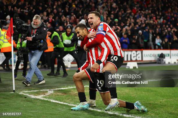 Iliman Ndiaye of Sheffield United celebrates with teammate Billy Sharp after scoring the team's first goal during the Emirates FA Cup Fifth Round...