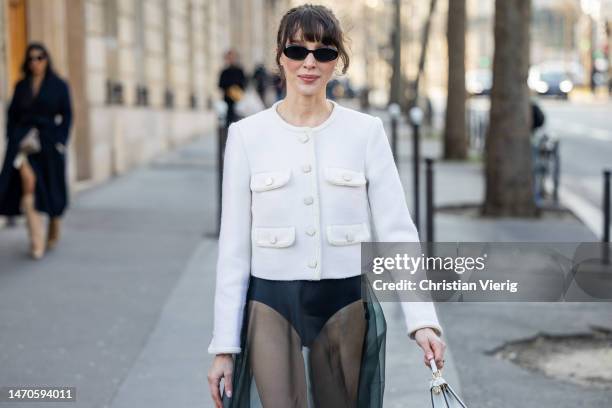 Mary Leest wears transparent skirt, white jacket, Fendi bag, grey knee high socks outside Cecilie Bahnsen during Paris Fashion Week - Womenswear Fall...