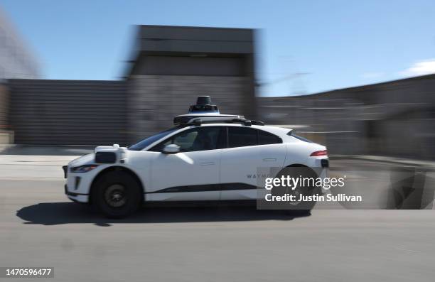 Waymo car drives along a street on March 01, 2023 in San Francisco, California. Waymo, Alphabet's self-driving car division, announced that it has...