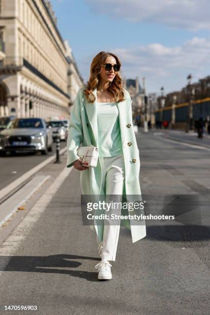 Alexandra Lapp is seen wearing COMMA double breasted coat in light mint, COMMA shirt in light mint, COMMA trousers in white, CHANEL flap bag in...