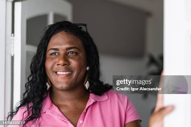 portrait of a transgender woman at home - transgender female stock pictures, royalty-free photos & images