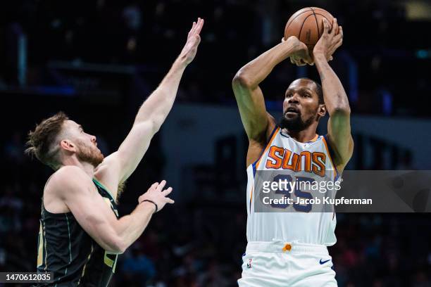 Kevin Durant of the Phoenix Suns shoots the ball while guarded by Gordon Hayward of the Charlotte Hornets in the first quarter during their game at...