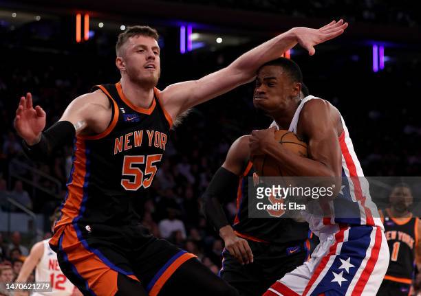 Nic Claxton of the Brooklyn Nets heads for the net as Isaiah Hartenstein of the New York Knicks defends during the first half at Madison Square...