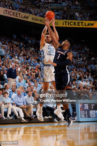 Pete Nance of the North Carolina Tar Heels shoots the ball over Jayden Gardner of the Virginia Cavaliers on February 25, 2023 at the Dean Smith...