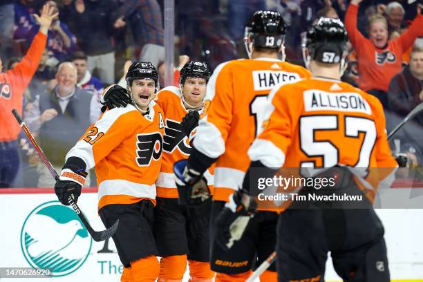 Scott Laughton of the Philadelphia Flyers celebrates with teammates after scoring during the second period against the New York Rangers at Wells...