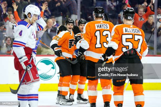 Scott Laughton of the Philadelphia Flyers celebrates with teammates after scoring during the second period against the New York Rangers at Wells...