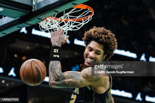 Kelly Oubre Jr. #12 of the Charlotte Hornets reacts after dunking the ball in the fourth quarter during their game against the Phoenix Suns at...
