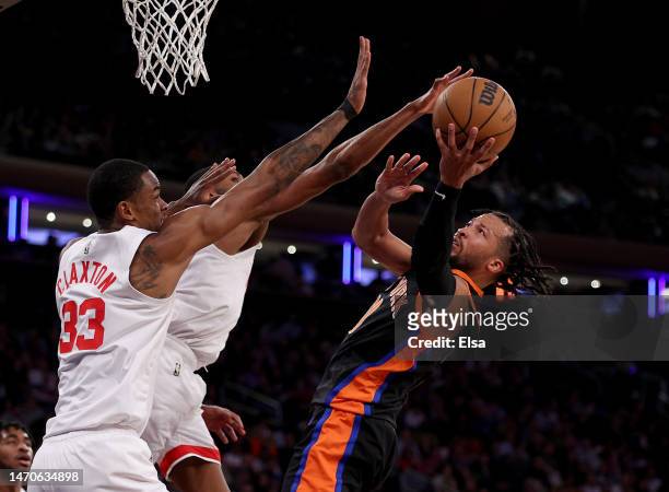 Jalen Brunson of the New York Knicks heads for the net as Nic Claxton anfd Mikal Bridges of the Brooklyn Nets defend in the second half at Madison...