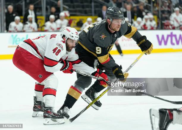 Jack Eichel of the Vegas Golden Knights battles Jordan Martinook of the Carolina Hurricanes during the first period at T-Mobile Arena on March 01,...
