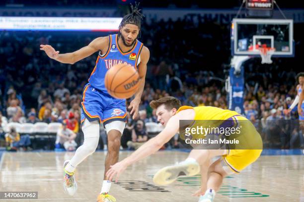 Austin Reaves of the Los Angeles Lakers loses the ball after colliding with Isaiah Joe of the Oklahoma City Thunder during the fourth quarter at...