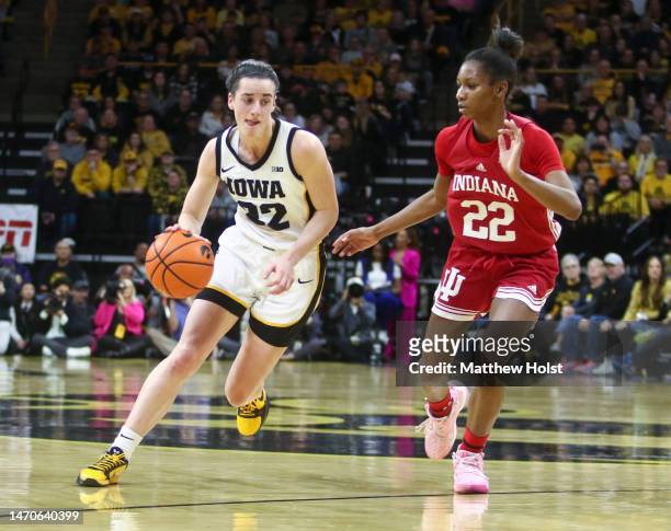 Guard Caitlin Clark of the Iowa Hawkeyes drives down the court during the first half against guard Chloe Moore-McNeil of the Indiana Hoosiers at...