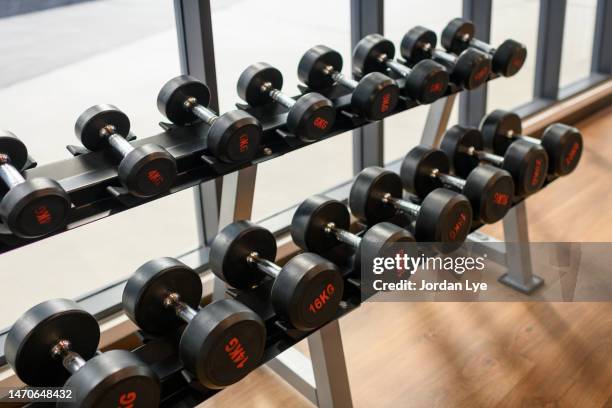 close up of dumbbells in health club - poids-et-haltères photos et images de collection