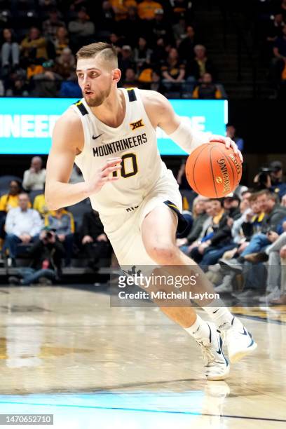 Erik Stevenson of the West Virginia Mountaineers dribbles the ball during a college basketball game against the Oklahoma State Cowboys at the WVU...