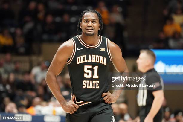 John-Michael Wright of the Oklahoma State Cowboys looks on during a college basketball game against the West Virginia Mountaineers at the WVU...