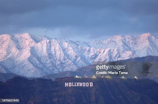 The Hollywood sign stands in front of snow-covered mountains after another winter storm hit Southern California on March 01, 2023 in Los Angeles,...