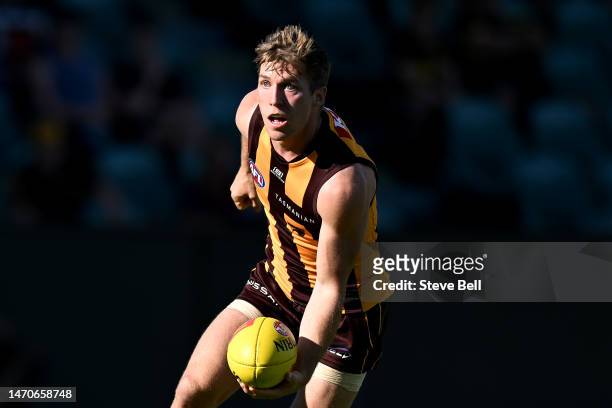 Dylan Moore of the Hawks handballs during the AFL practice match between the Hawthorn Hawks and the Collingwood Magpies at University of Tasmania...
