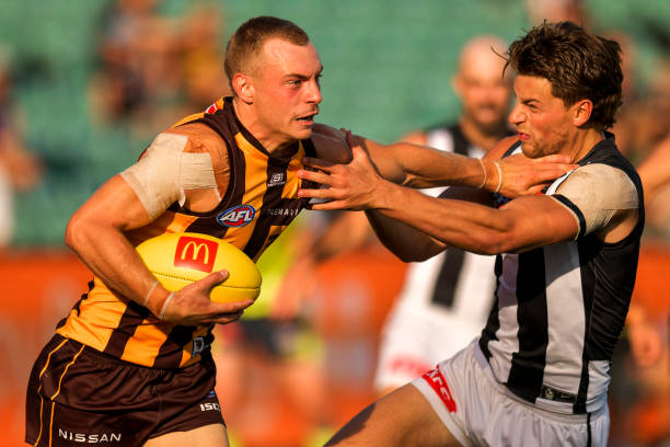 James Worpel of the Hawks breaks a tackle during the AFL practice match between the Hawthorn Hawks and the Collingwood Magpies at University of...