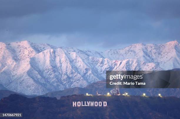 The Hollywood sign stands in front of snow-covered mountains after another winter storm hit Southern California on March 01, 2023 in Los Angeles,...