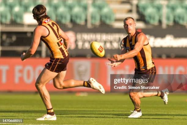 James Worpel of the Hawks handballs during the AFL practice match between the Hawthorn Hawks and the Collingwood Magpies at University of Tasmania...