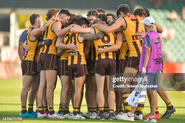 Hawthorn players huddle ahead of the second half during the AFL practice match between the Hawthorn Hawks and the Collingwood Magpies at University...