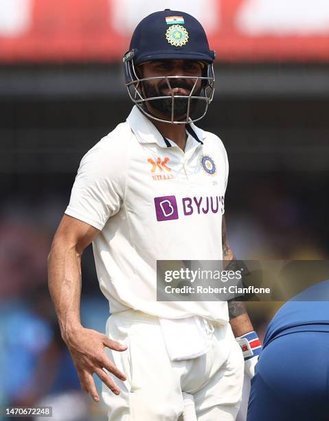 Virat Kohli of India reatcs after he was struck on the hand during day two of the Third Test match in the series between India and Australia at...
